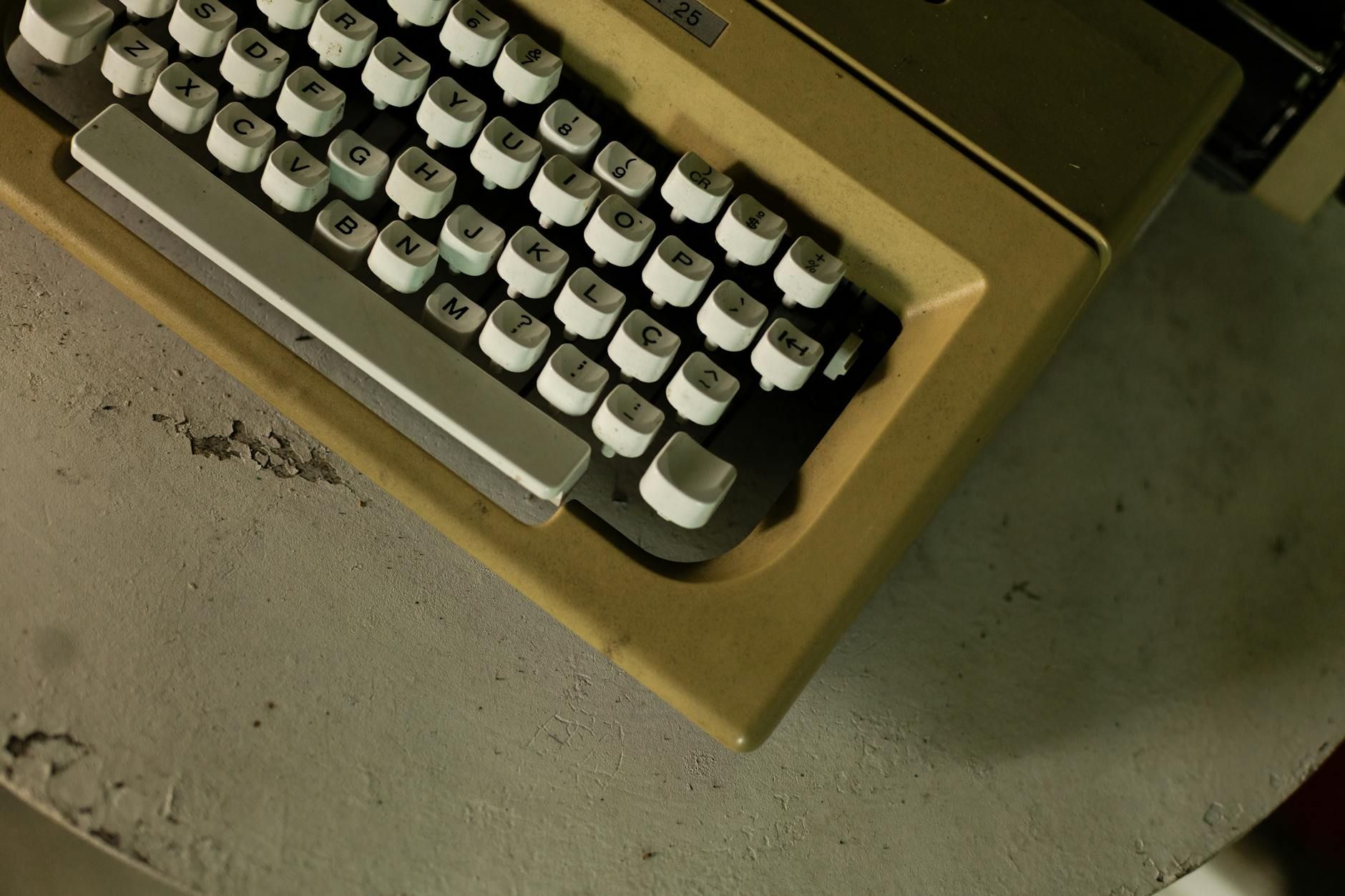 Close-up of an old typewriter on a rustic surface, evoking nostalgia.